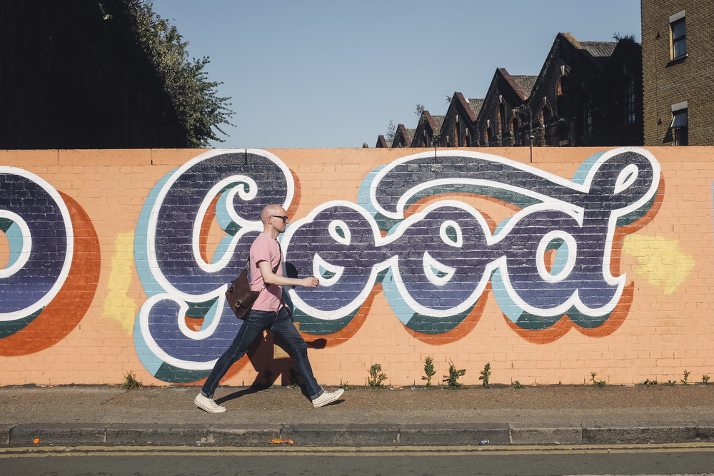 Bald_man_walks_in_front_of_graffiti_%28Unsplash%29.jpg