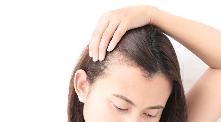 Woman_examining_hair_line.jpg